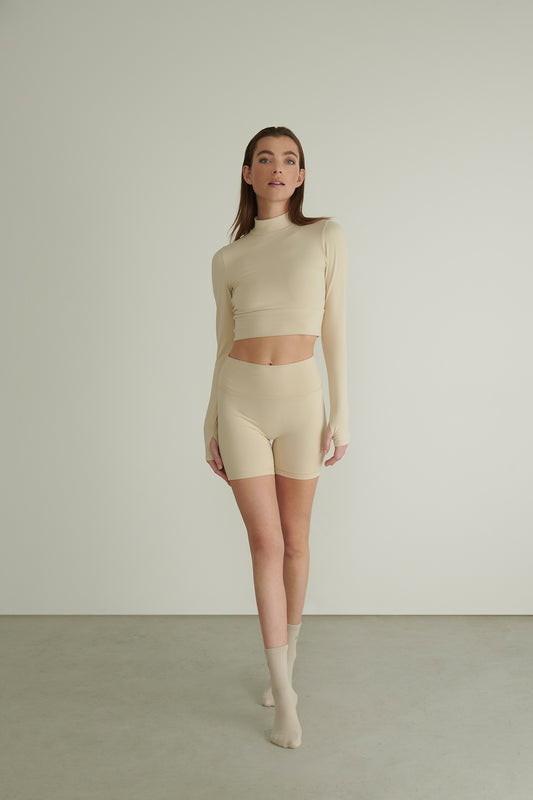 Model Wearing the Beige Vital Outfit with Biker Short